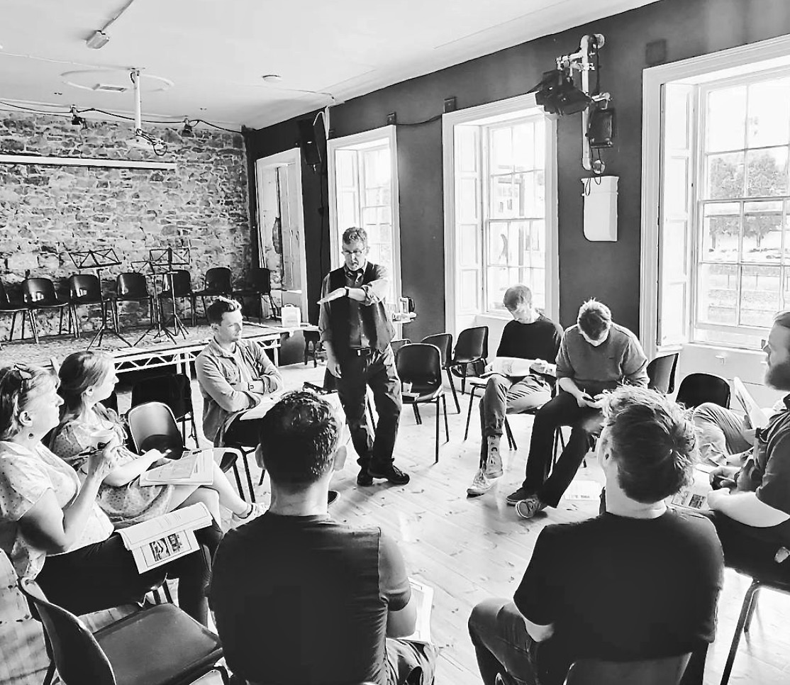 Timothy X. Troy leads a reading of Run with the Hare (…and hunt with the hound) when it was presented by KATS Theatre Group + Barnstorm Studio at the Home Rule Club in Kilkenny, Ireland, in June. 