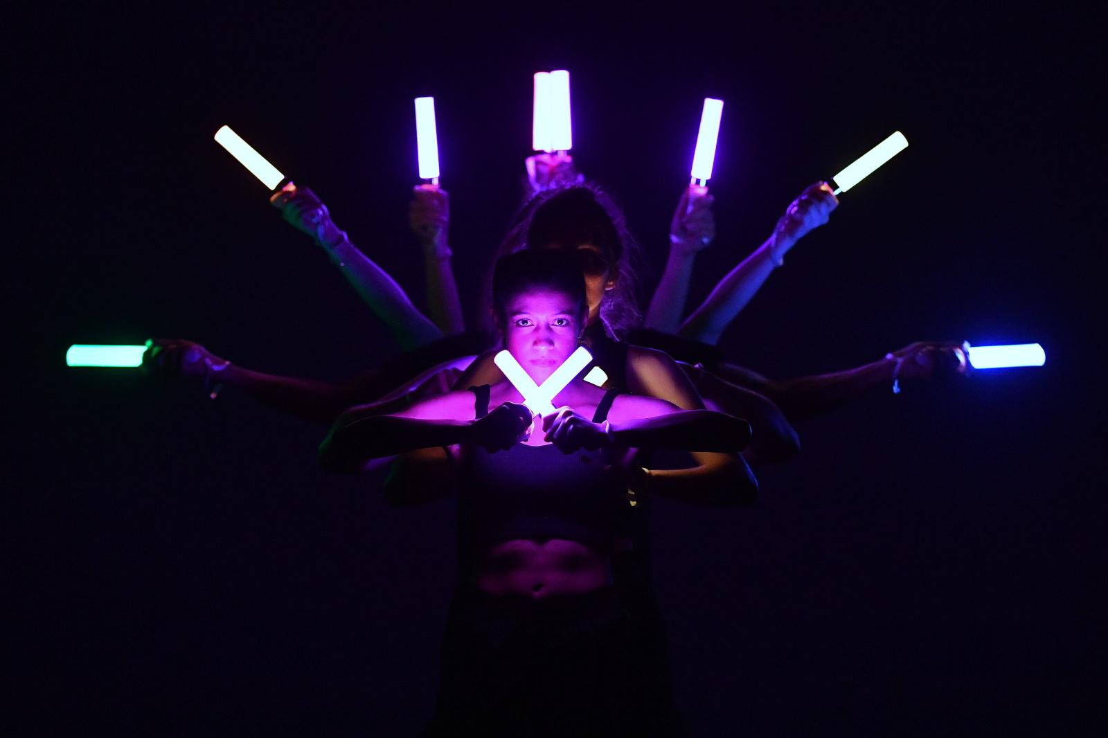Performers hold lights during a dance performance at Cabaret.
