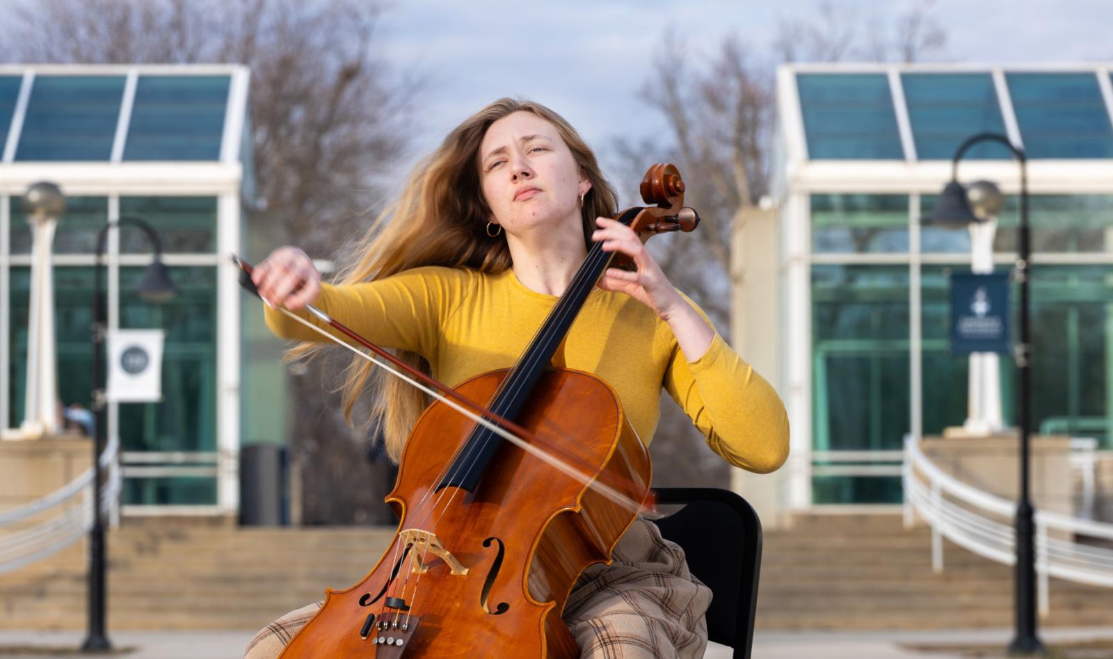 Annika Schmidt plays the cello outside of the Music-Drama Center.