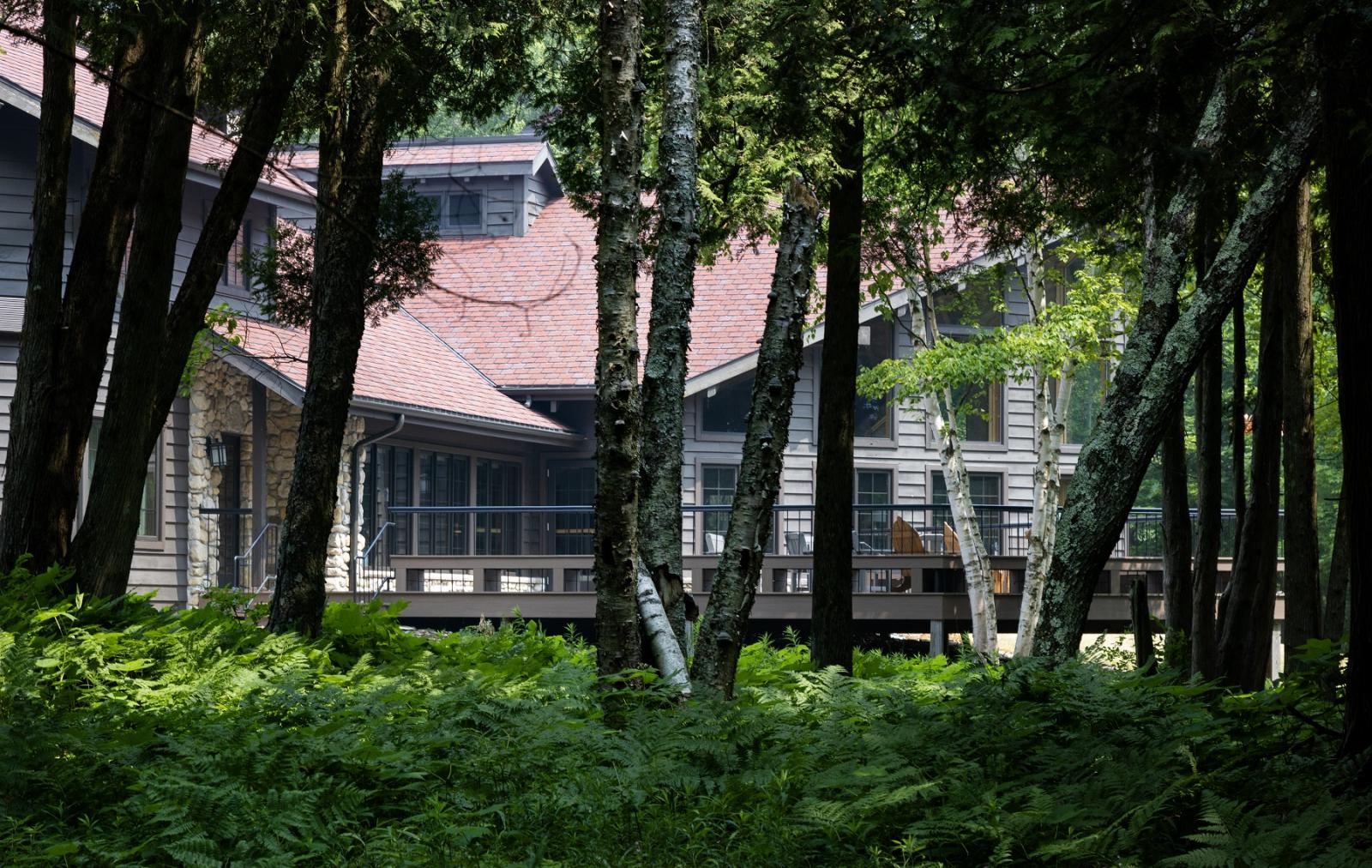 The lodge at Bjorklunden is seen through the trees. 