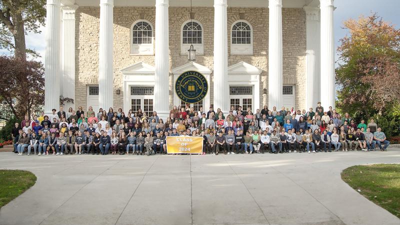 Class of 2024 in front of Main Hall with Lawrence Seal.