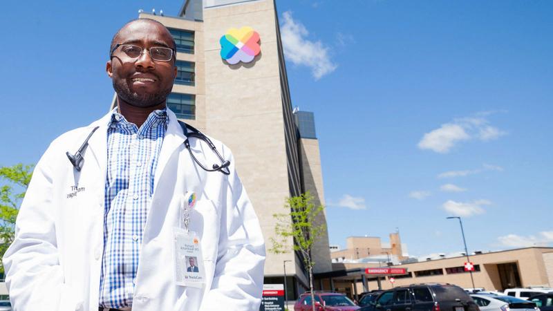 Doctor standing in front of Theda Care hospital in Appleton, WI