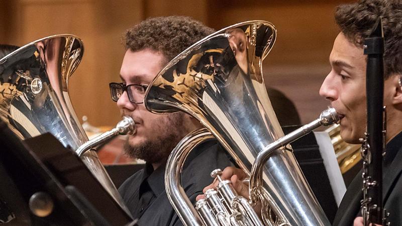 Two students play euphonium on stage in Memorial Chapel