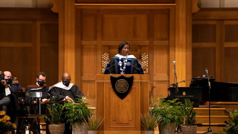 President Laurie Carter speaks at the podium on the stage of Memorial Chapel.