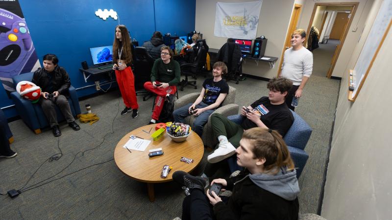 Students gather to play video games in the Esports gaming lounge.