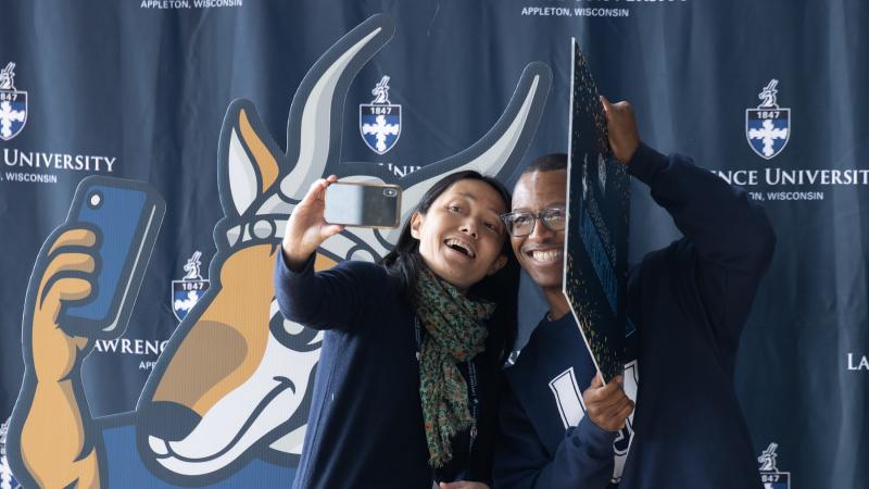 Students and alumni take selfies together during the 2023 Forever a Lawrentian events. 