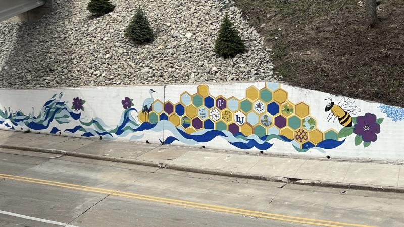 Wall mural with bee colorful honeycomb and water