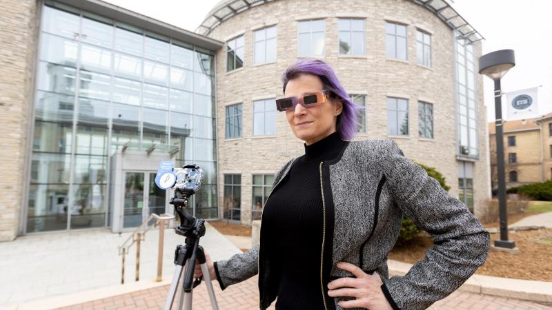 Physics professor Megan Pickett is geared up for Monday's eclipse. (Photo by Danny Damiani)