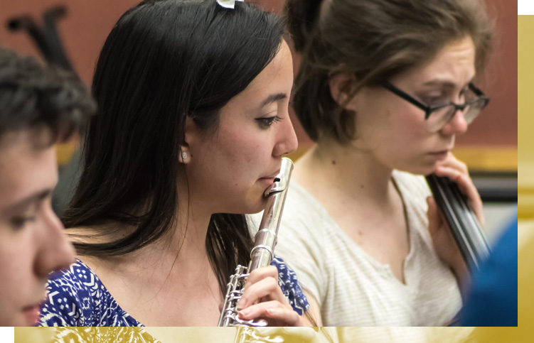 A student plays the flute in class.