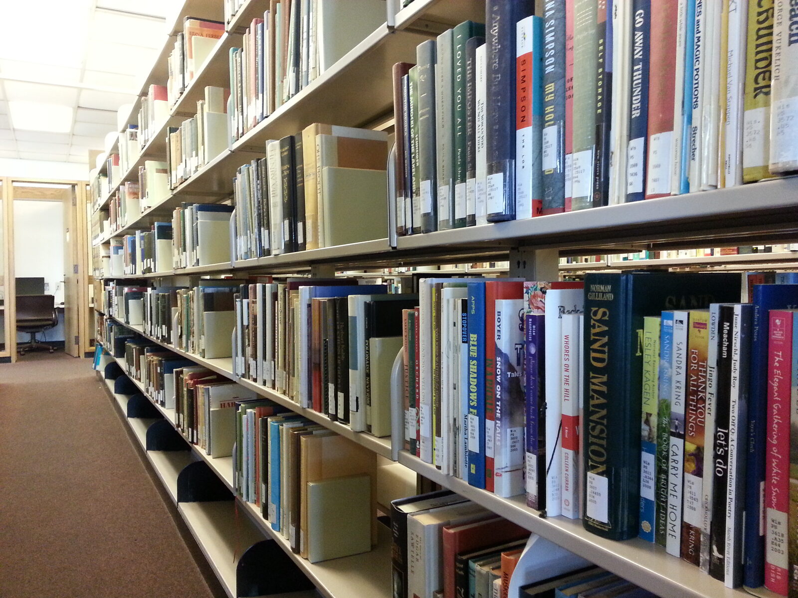 view down an aisle of books in the library