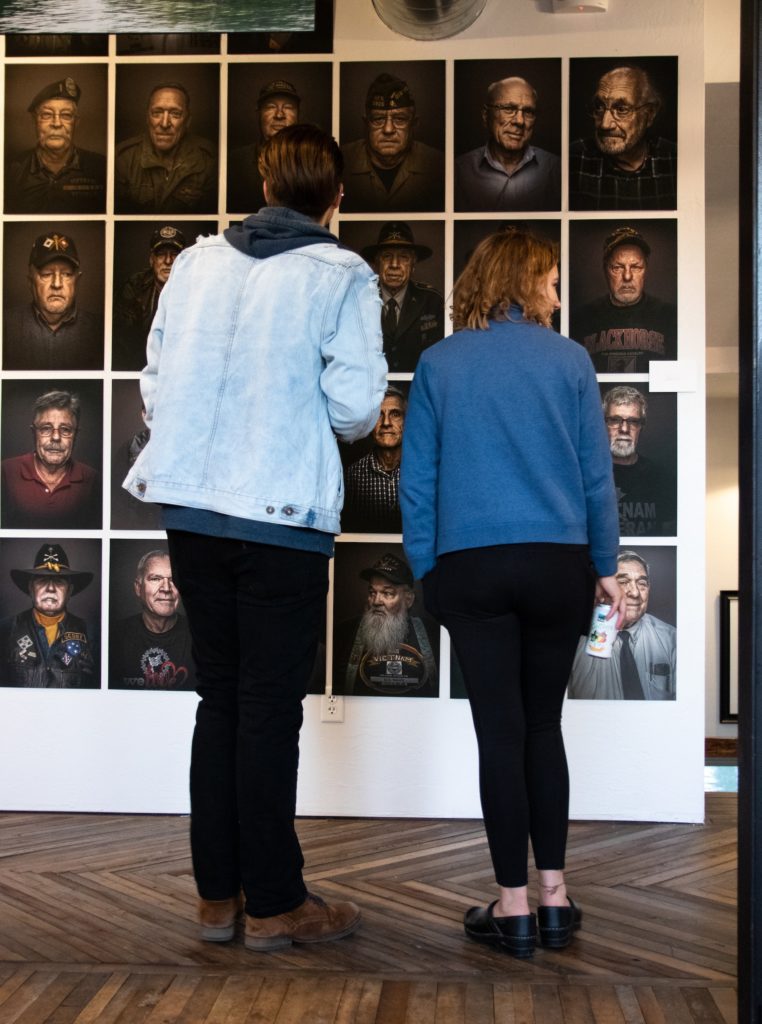 Two students looking at art.