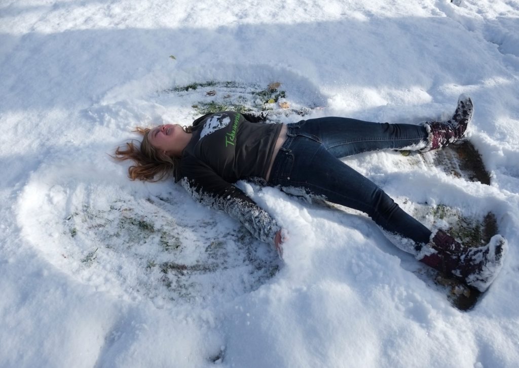 Shae Erlandson makes a snow angel on Main Hall Green.