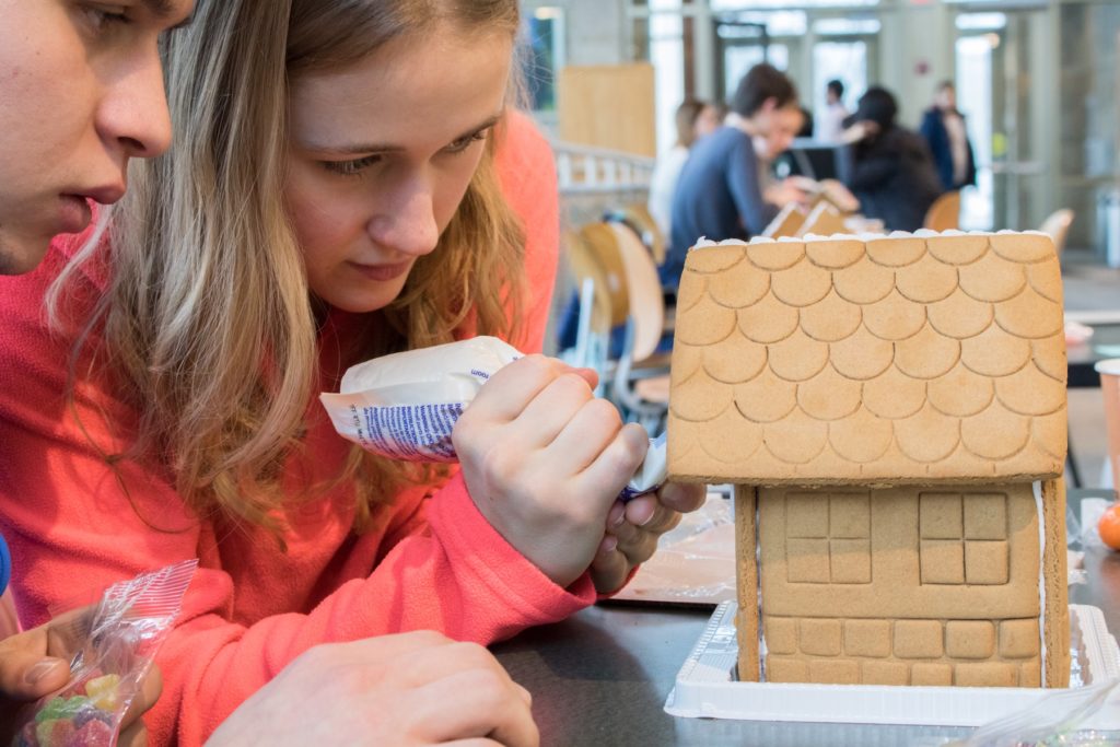 Students making gingerbread house