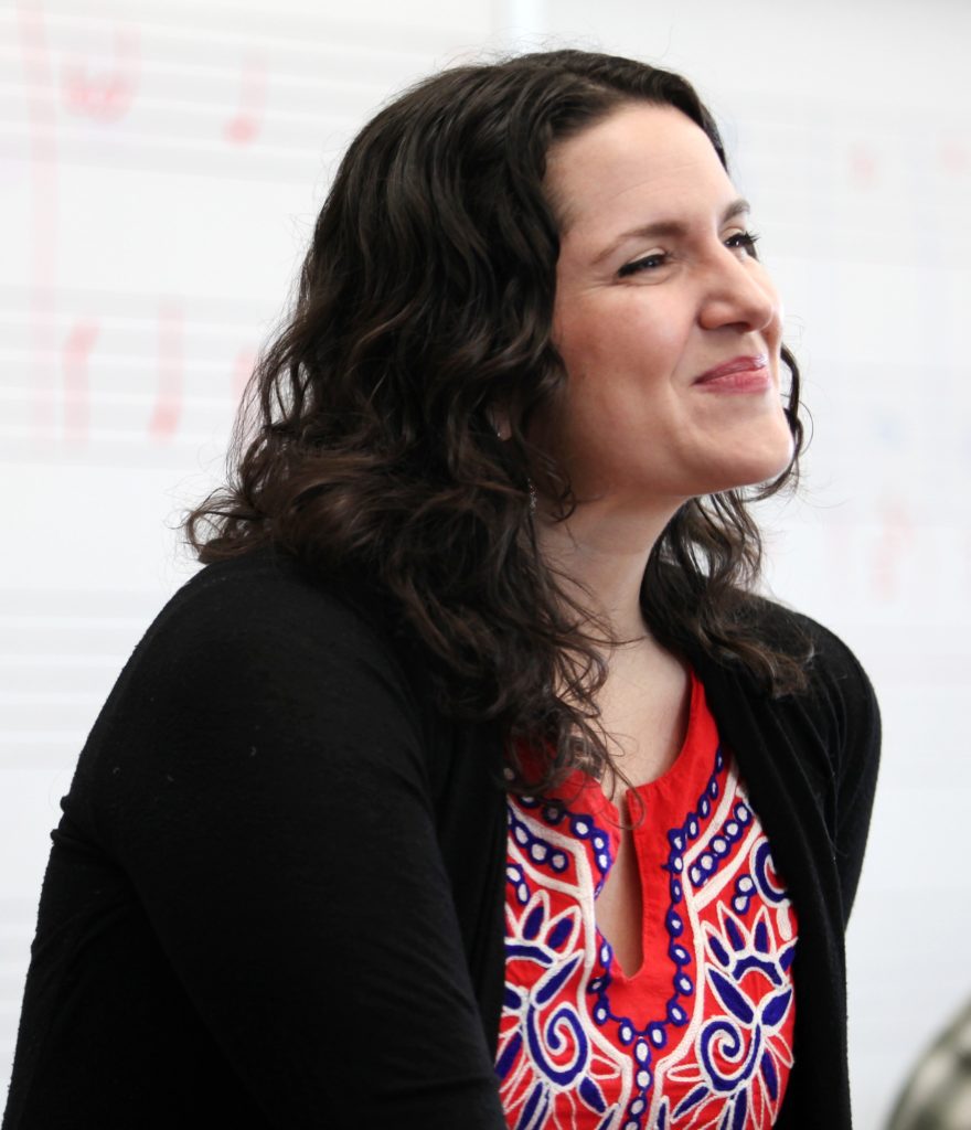 Estelí Gomez smiles as she talks with students in a studio class.