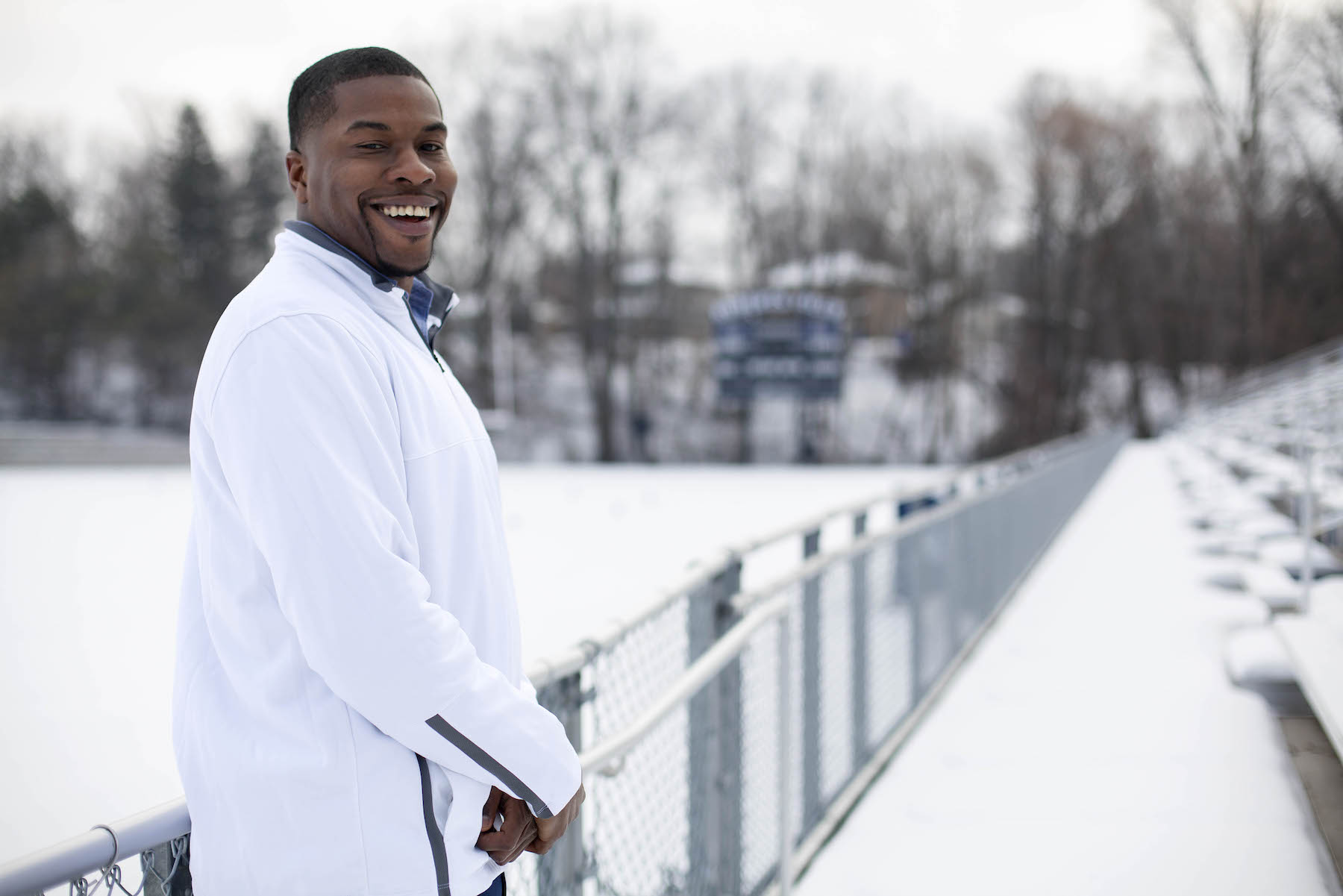 Tony Aker poses for a photo outside the fence at a snow-covered Banta Bowl.