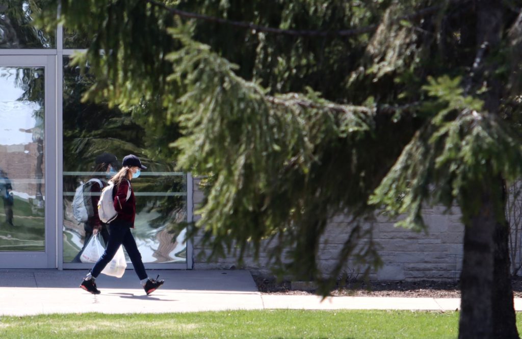 student wearing mask on campus