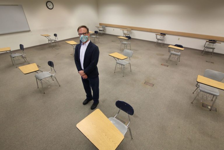 David Berk, director of instructional technology, shows what a classroom adjusted for physical distancing will look like during Fall Term.