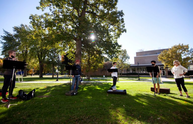 Director Patty Darling (far right) leads the horn section of the Lawrence University Jazz Ensemble through a rehearsal on the lawn outside the Music-Drama Center.