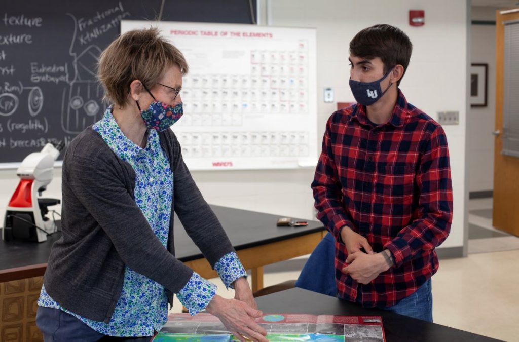 Professor Bjornerud talking to a student in a classroom