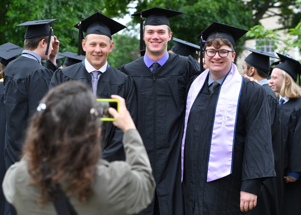 Participating queer-identifying students are presented with Pride stoles 