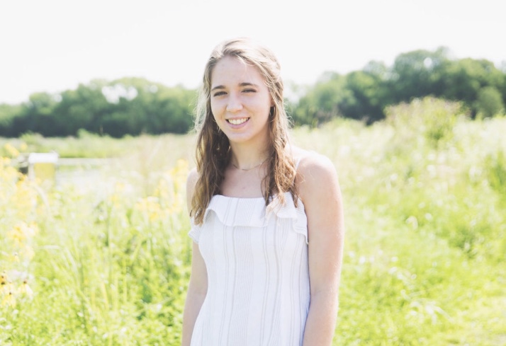 Natalie LaMonto, a Lawrence student, surrounded by trees and greenery 