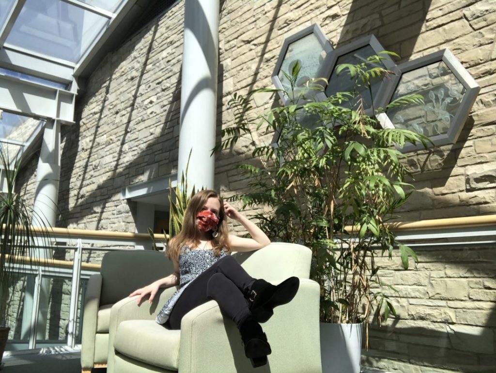 Student in a couch in Steitz Atrium