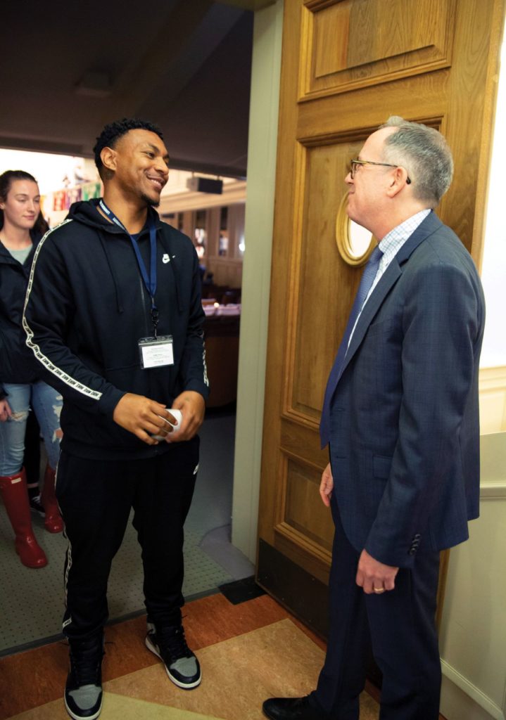 Mark Burstein talking to student during handshake ceremony