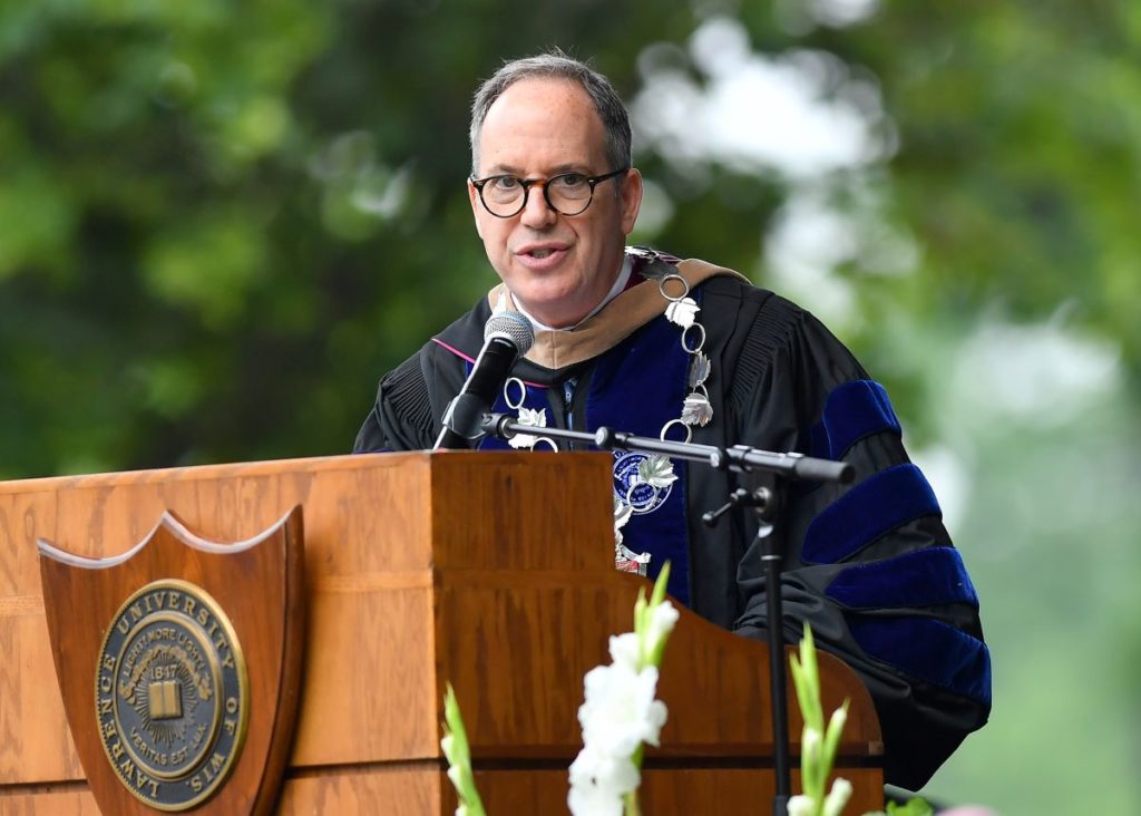 Mark Burstein speaking at the podium during commencement 