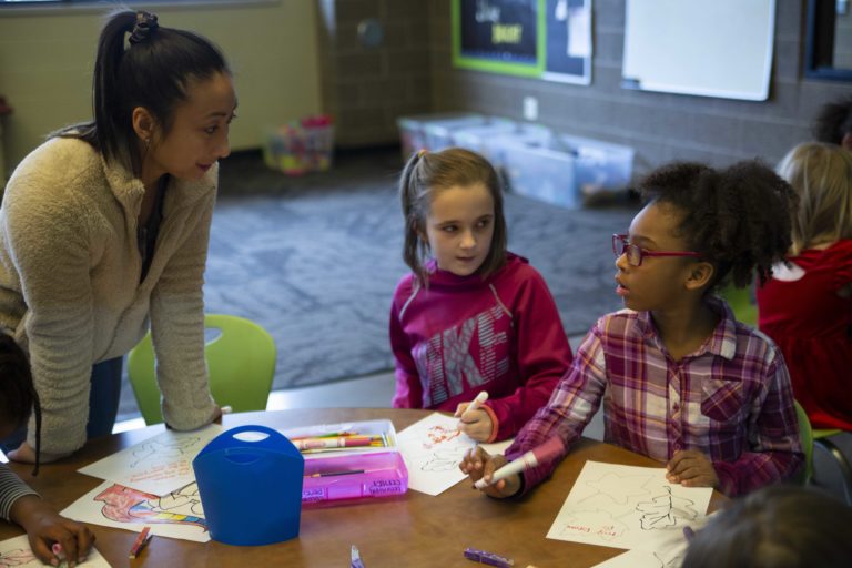 Student Beatrice Gee interacts Monday with kids at the Boys and Girls Club in Menasha