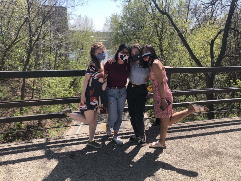 four students gather to take a picture in the Colman bridge