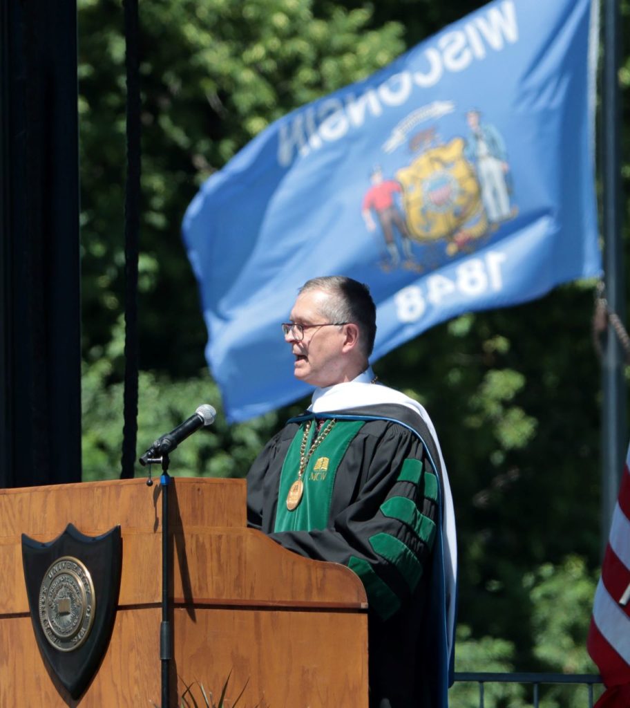 Dr. Raymond behind the podium during commencement 