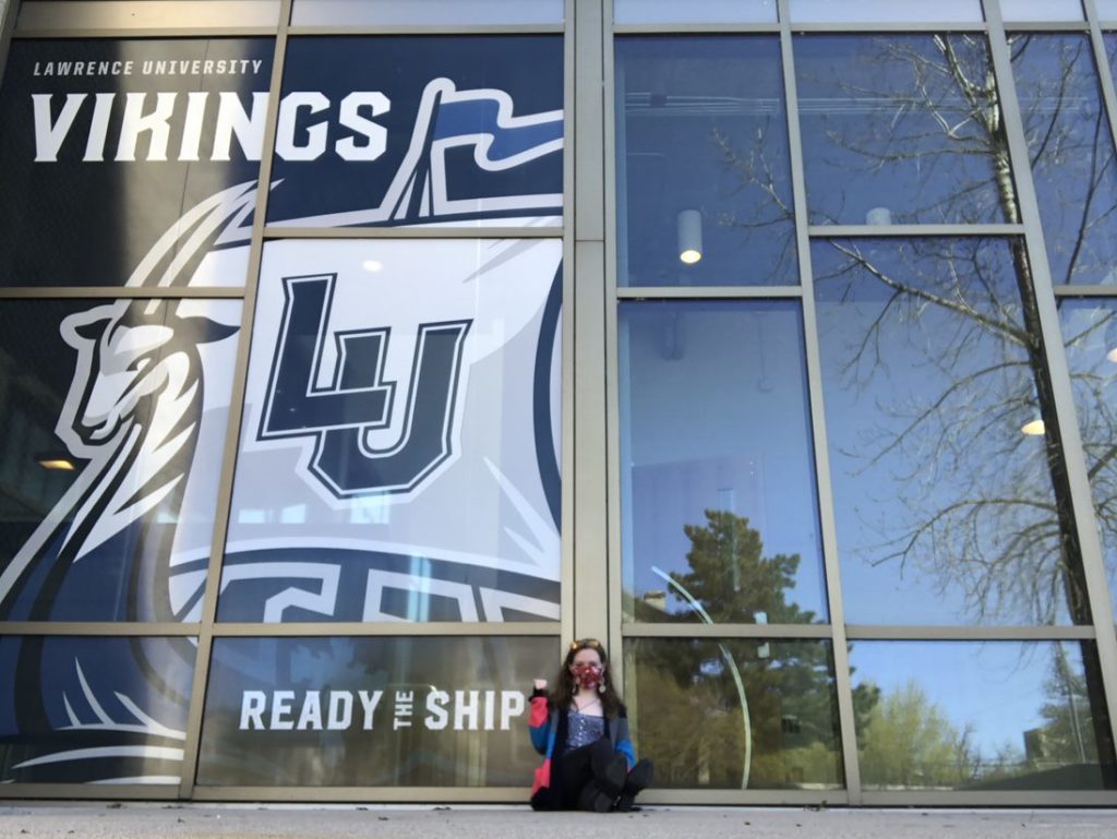 Student sitting in front of the Ready the Ship University logo 