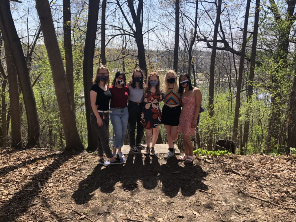six students gather to take picture in the Trever Woods