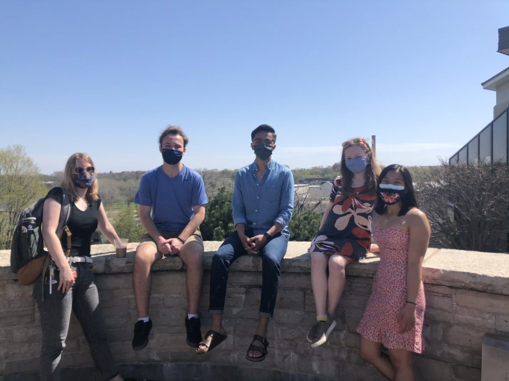 five students take picture in a ledge that overlooks the Fox river