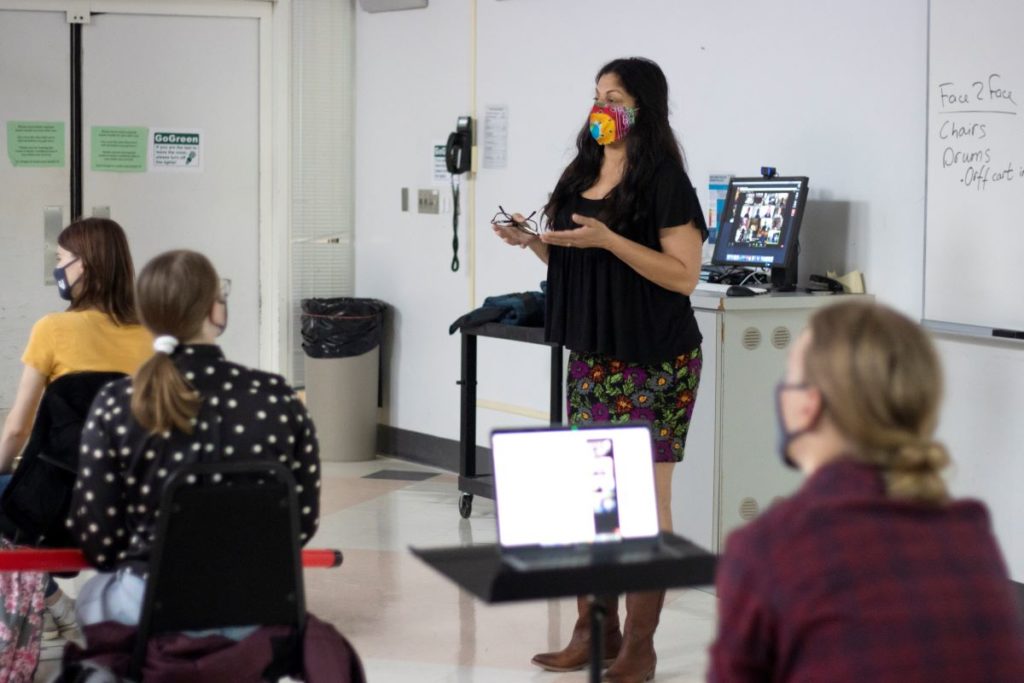 Professor Leila Pertl giving class while wearing a colorful mask