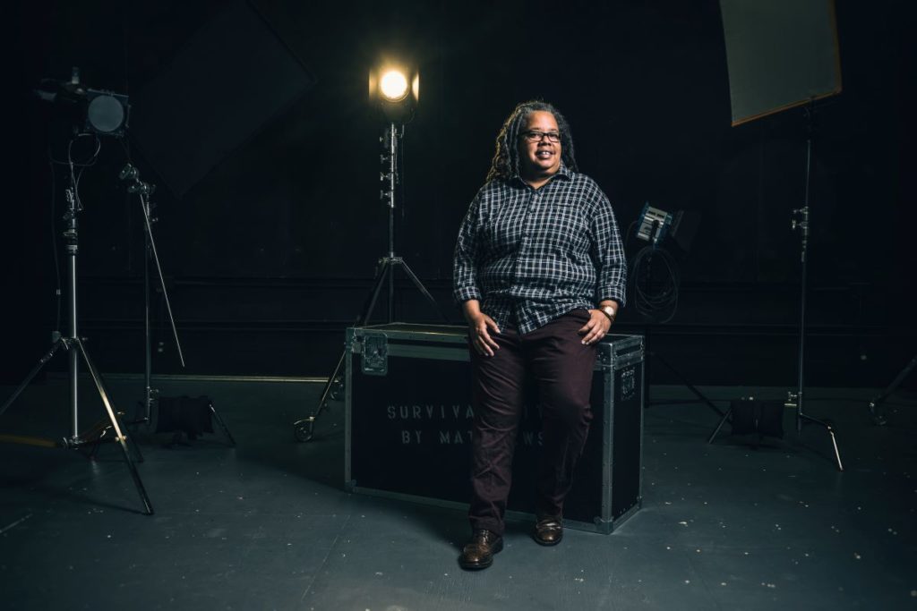 Professor Ongiri in the film studio surrounded by lighting equipment  