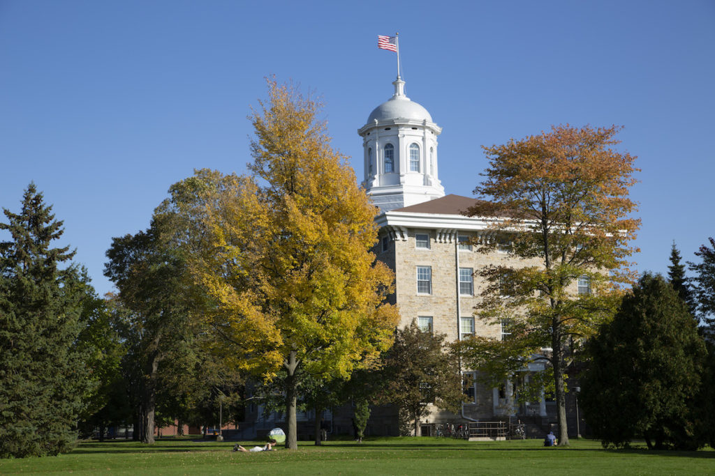 Sunny day at Main Hall with the leaves on trees turning brown 