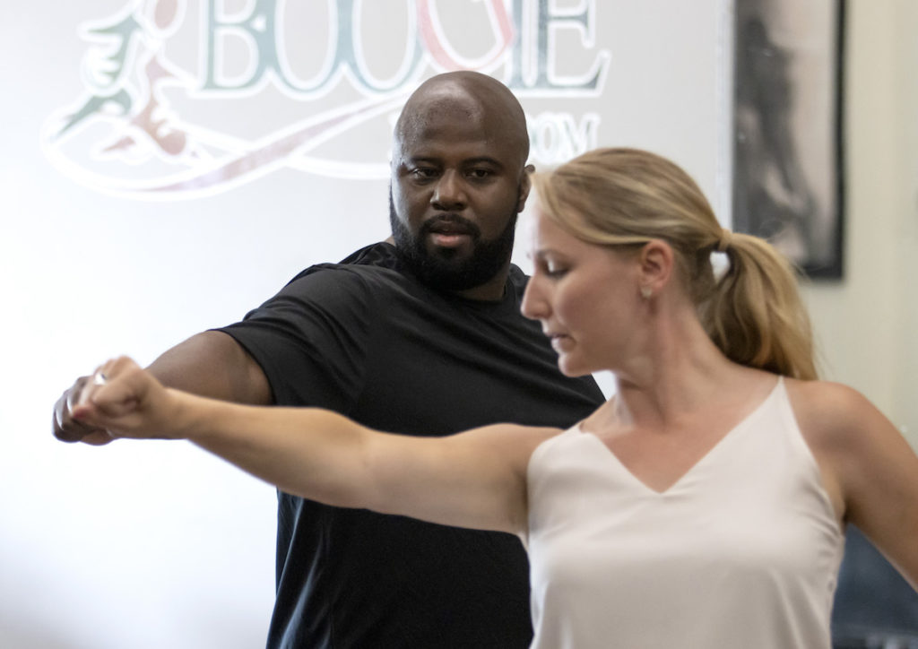 Jesus Smith practicing with a choreographer 