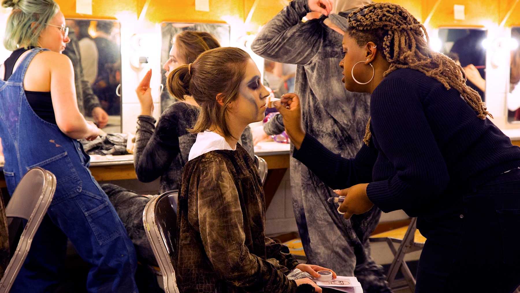 Makeup and costume work is done in advance of a dress rehearsal for "Mass."