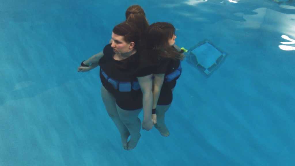 Dancers float in the water as part of "Breathe."