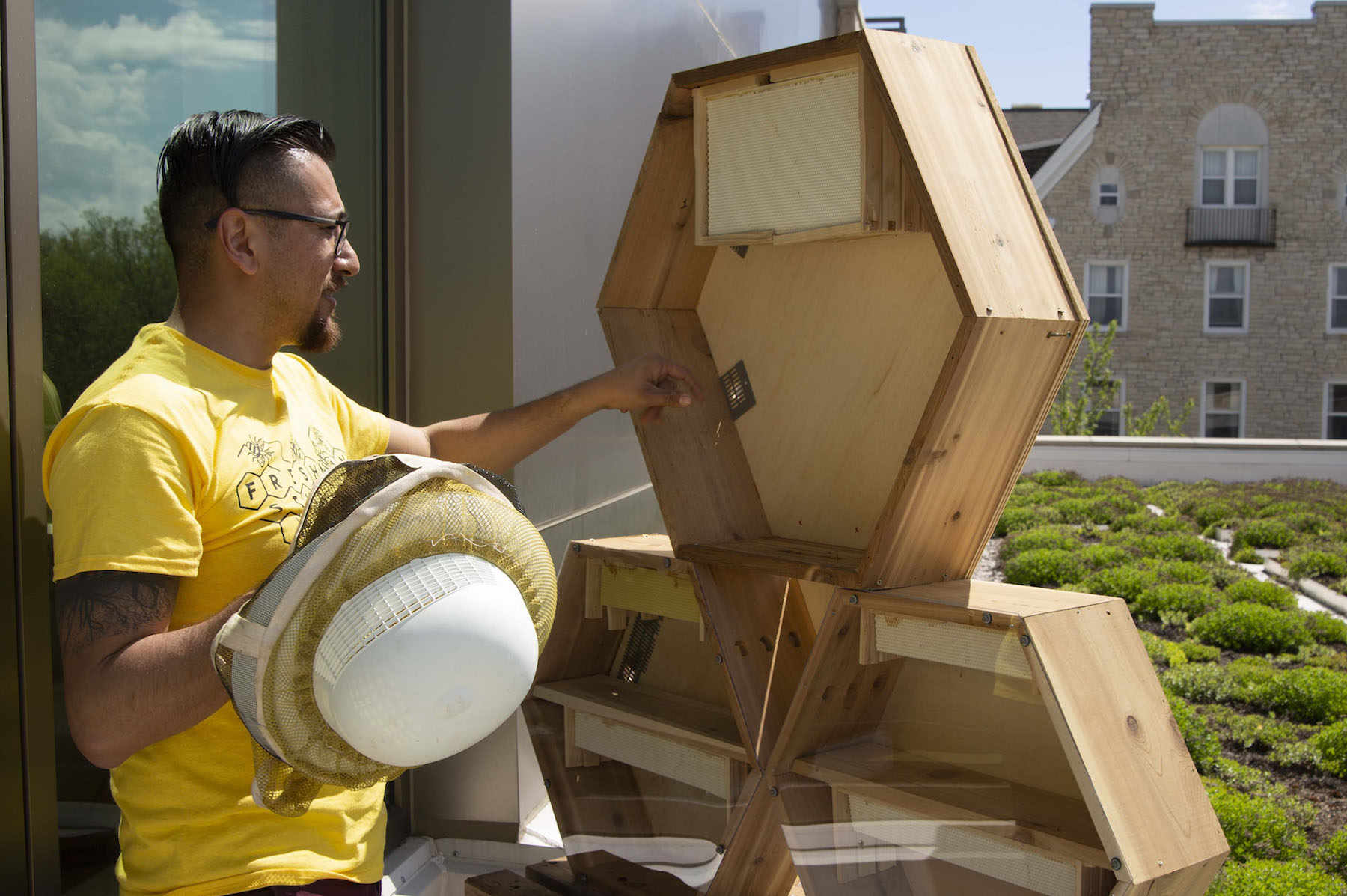 Professor Del Toro tending to unused bee hive.