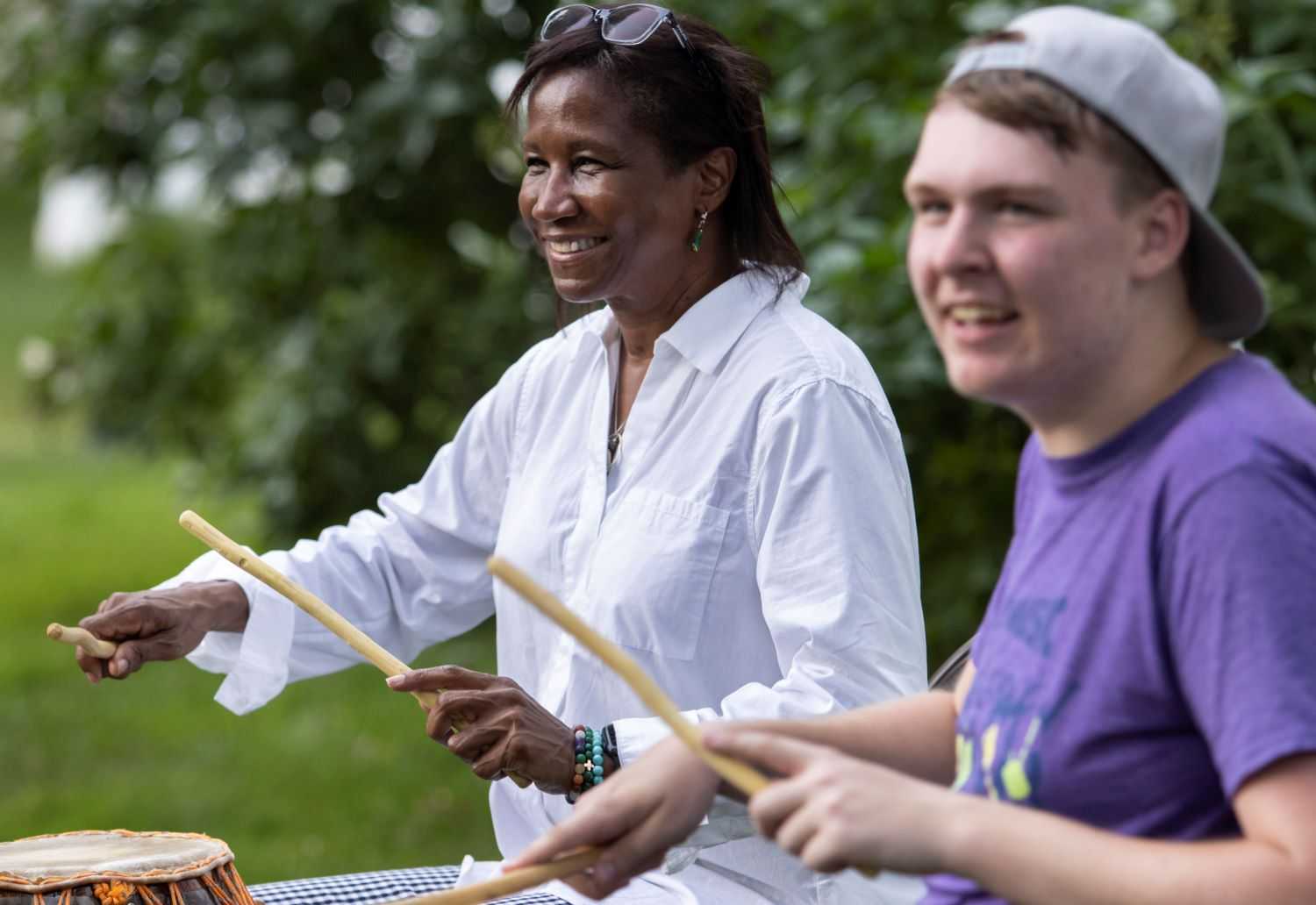 President Laurie Carter joins a percussion session during Mile of Music.
