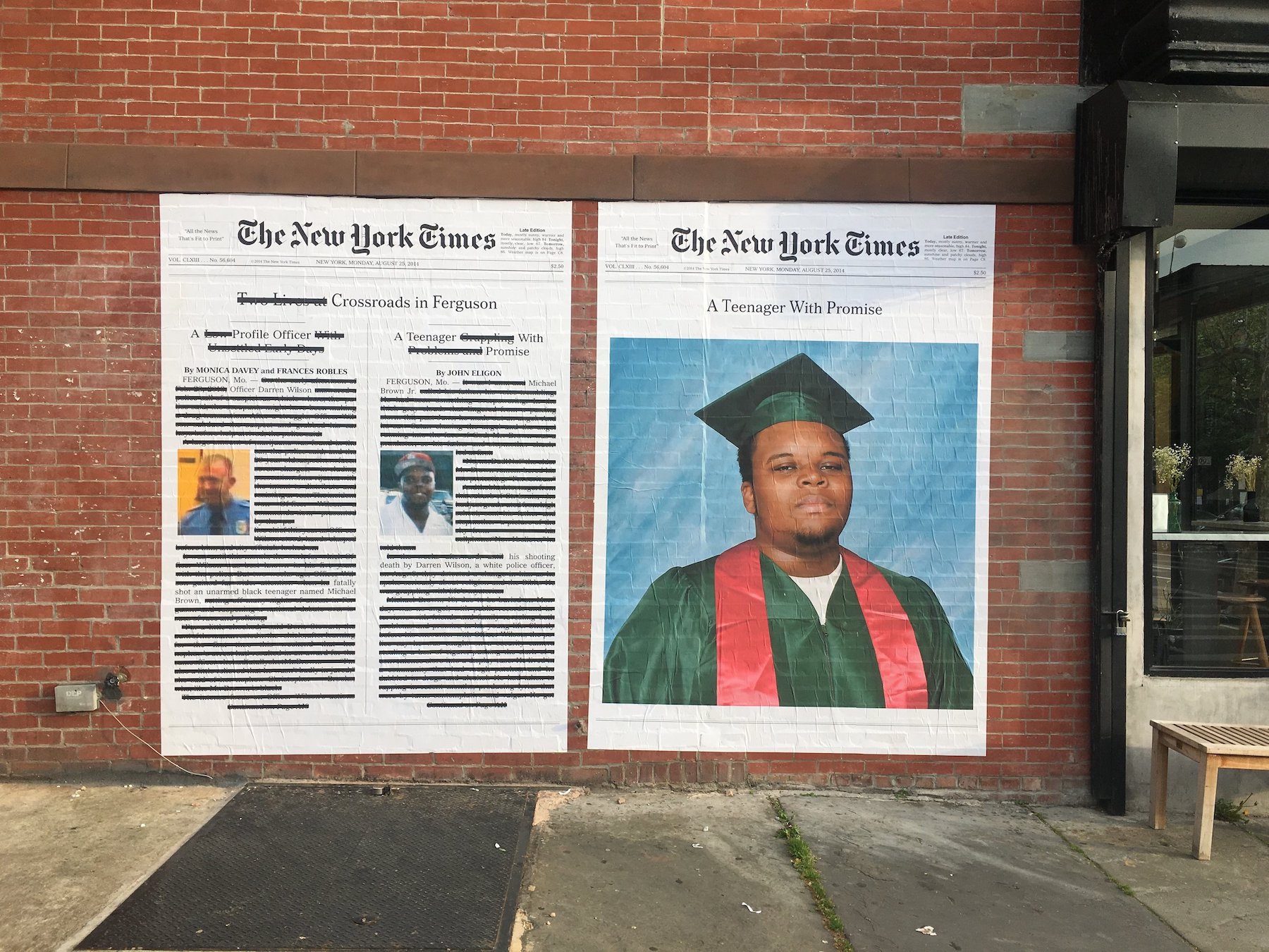 Alexandra Bell's marked up pages of the New York Times featuring the death of Michael Brown hang on a brick wall in Brooklyn, New York.