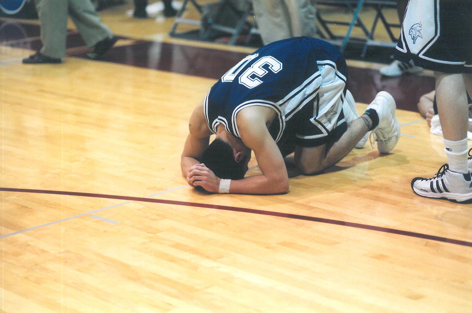 Rob Nenahlo falls to the floor as the game against UWSP ends 