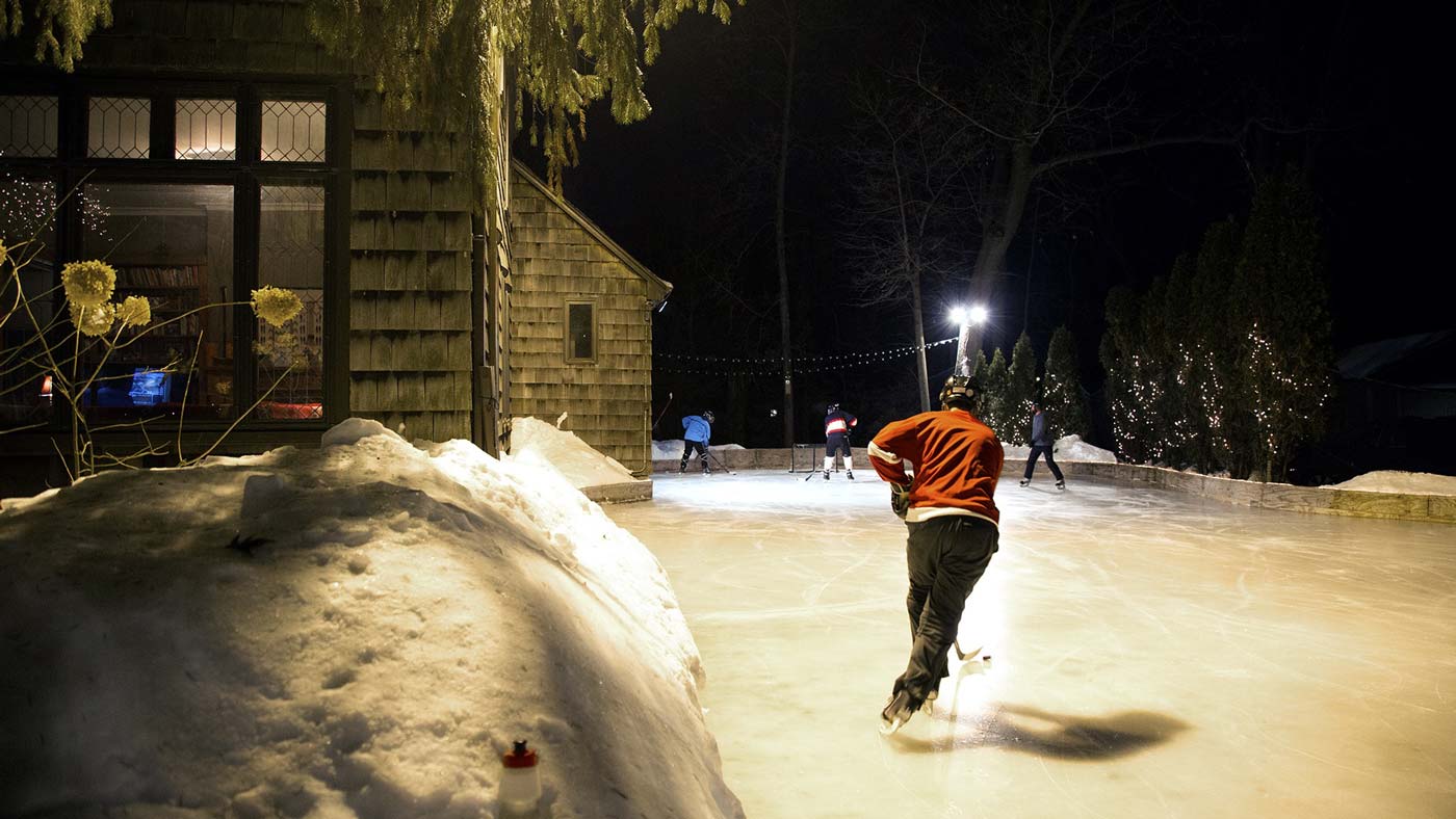 Hockey player skating on outdoor ice rink