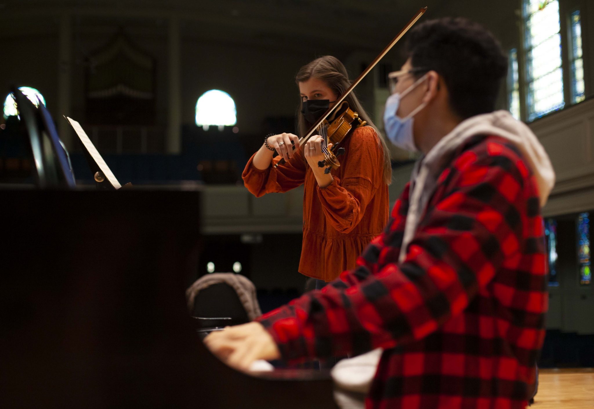 Student accompanies on piano while another student plays violin during violin studio.