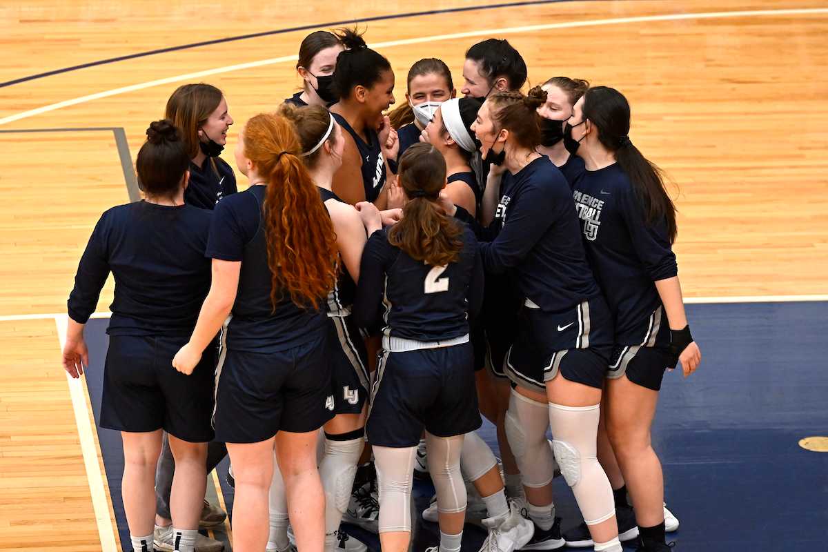 Kenya Earl stands with her teammates as they get fired up before the season finale.