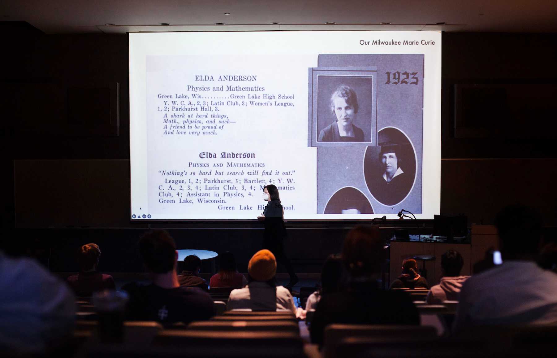 With a large screen behind her showing a Green Lake High School yearbook entry about Elda Anderson, Megan Pickett talks about Anderson's remarkable life during a presentation on campus in Winter Term.