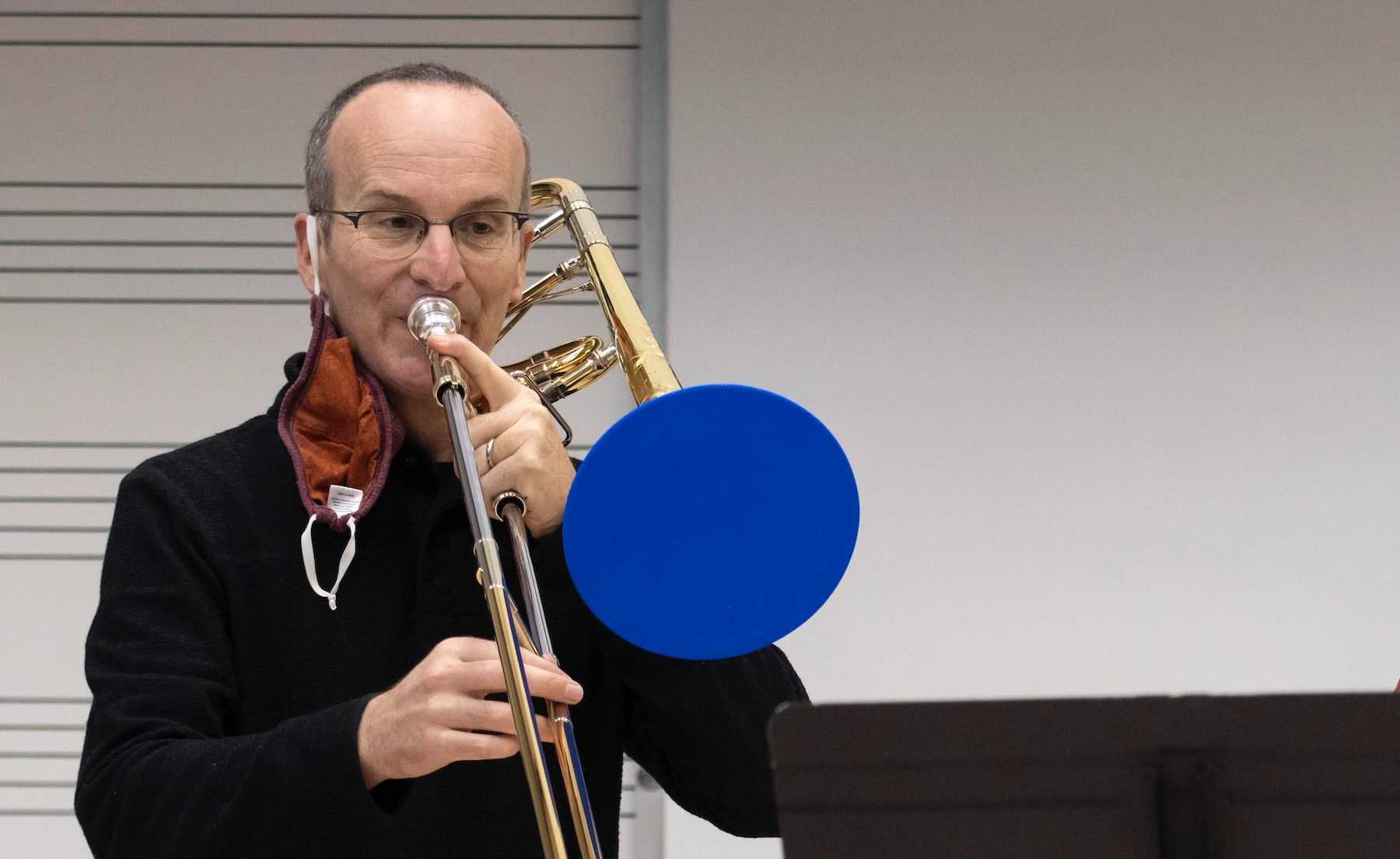 Tim Albright plays the trombone during a teaching session.