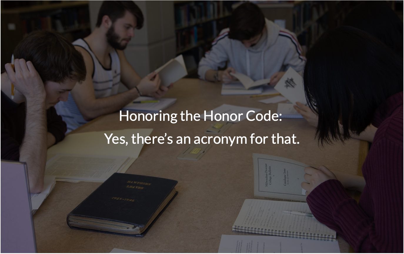 Students sit around table in library with historical documents. In the foreground is text that says, "Honoring the Honor Code: yes, there's an acronym for that."